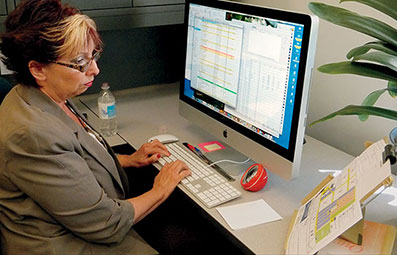 Prepress lady at computer working